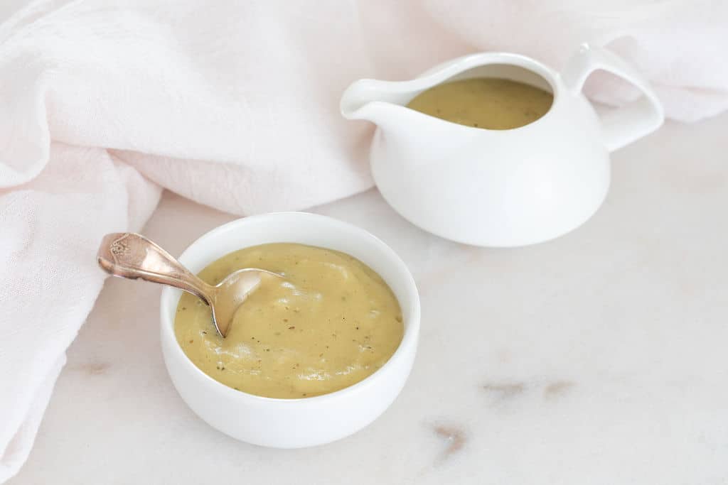 completed Vegan Simple Gravy in gravy pot and in bowl against white background