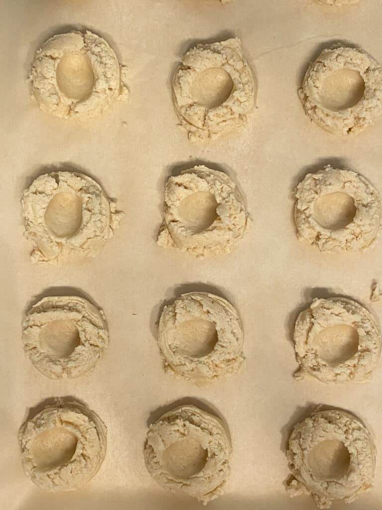 several pre-baked cookies with imprint on baking sheet