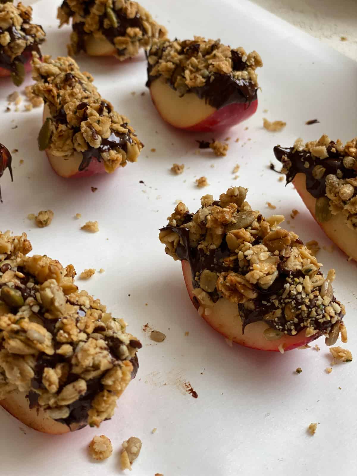 several Healthy Apple Snacks with Granola against a white surface
