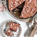 completed slice of Silken Chocolate Peppermint Pie plated with more pie in the background