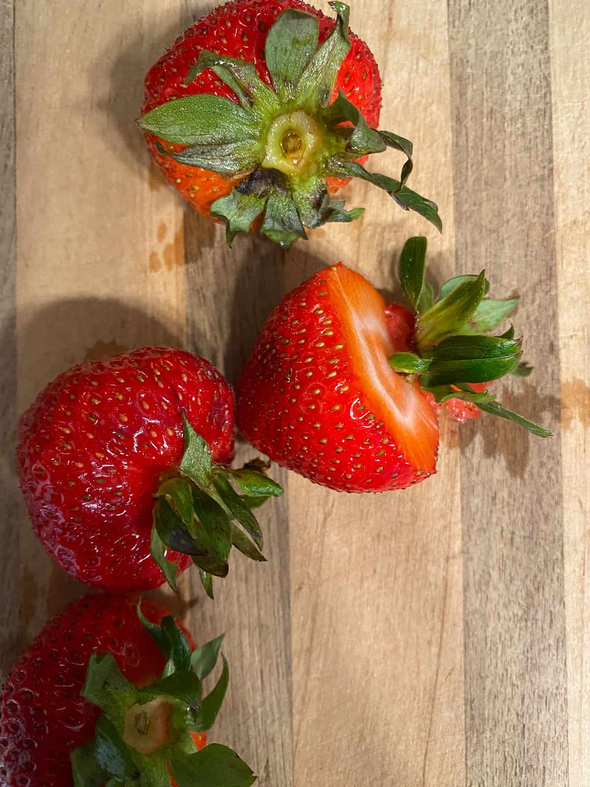 process shot showing cut strawberries on a cutting board