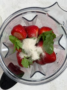 process shot showing addition of ingredients into blender