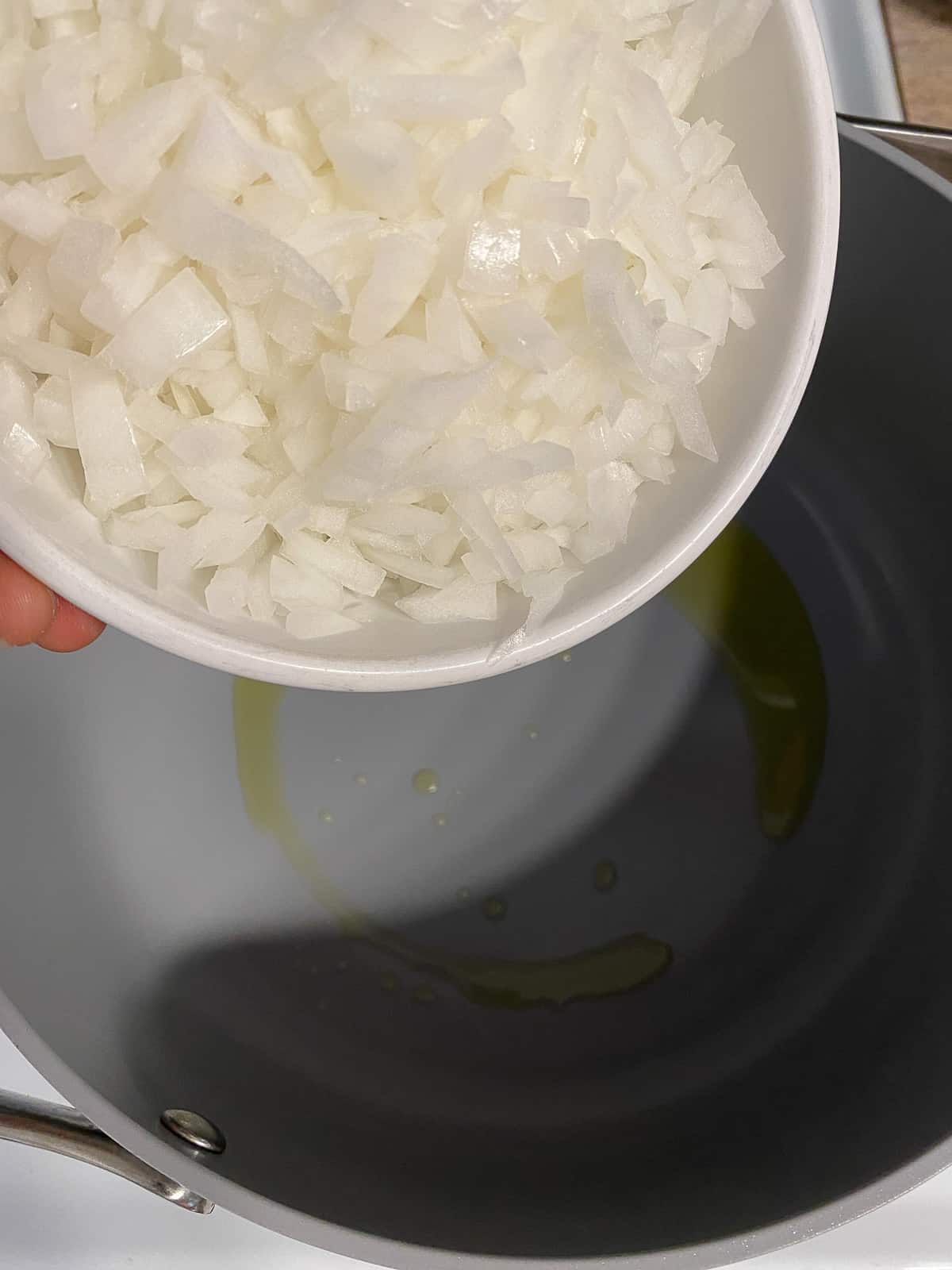 process shot of adding onion to pan