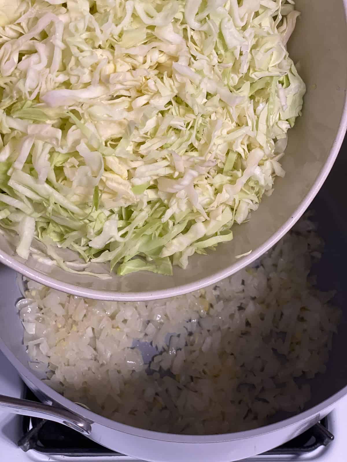 process shot of adding cabbage to pan