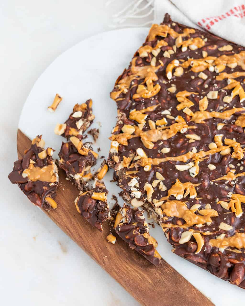 completed Chocolate Peanut Butter Bark on a cutting board with several pieces broken off