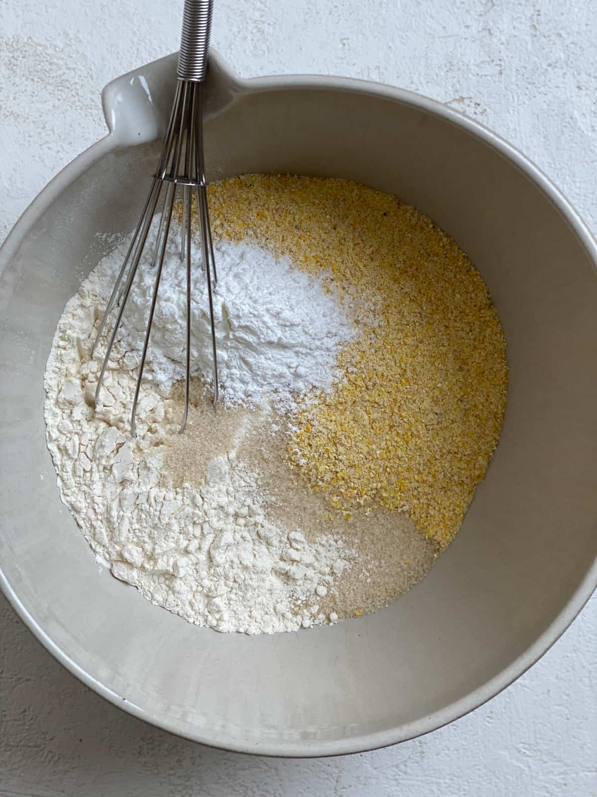 process shot of mixing dry ingredients for Vegan Cornbread Recipe Cast Iron Skillet in a bowl