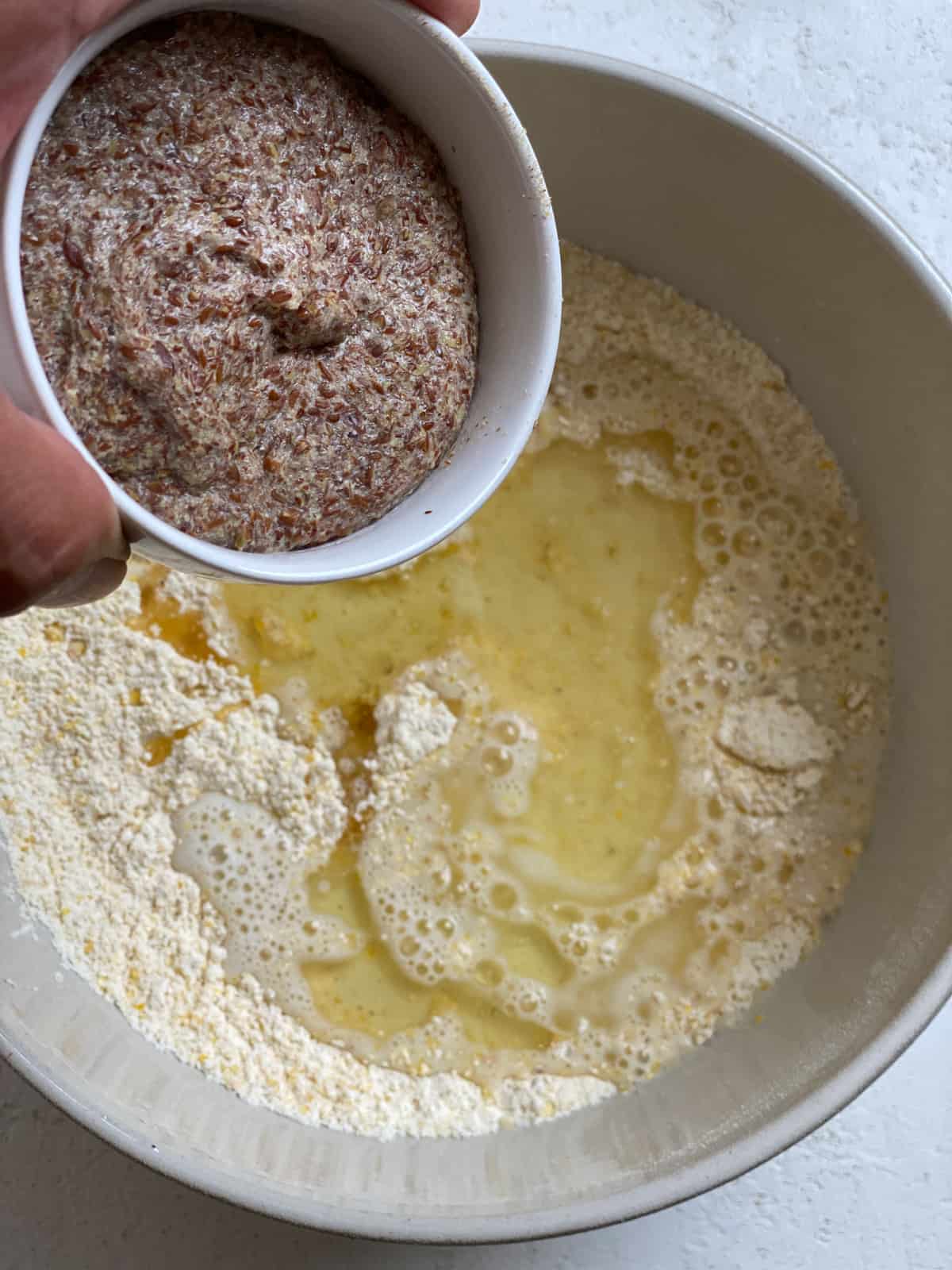 process shot of adding flaxseed mixture to bowl