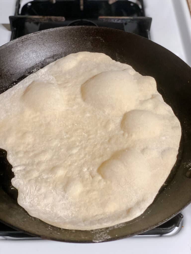 process shot showing tortilla cooking on pan