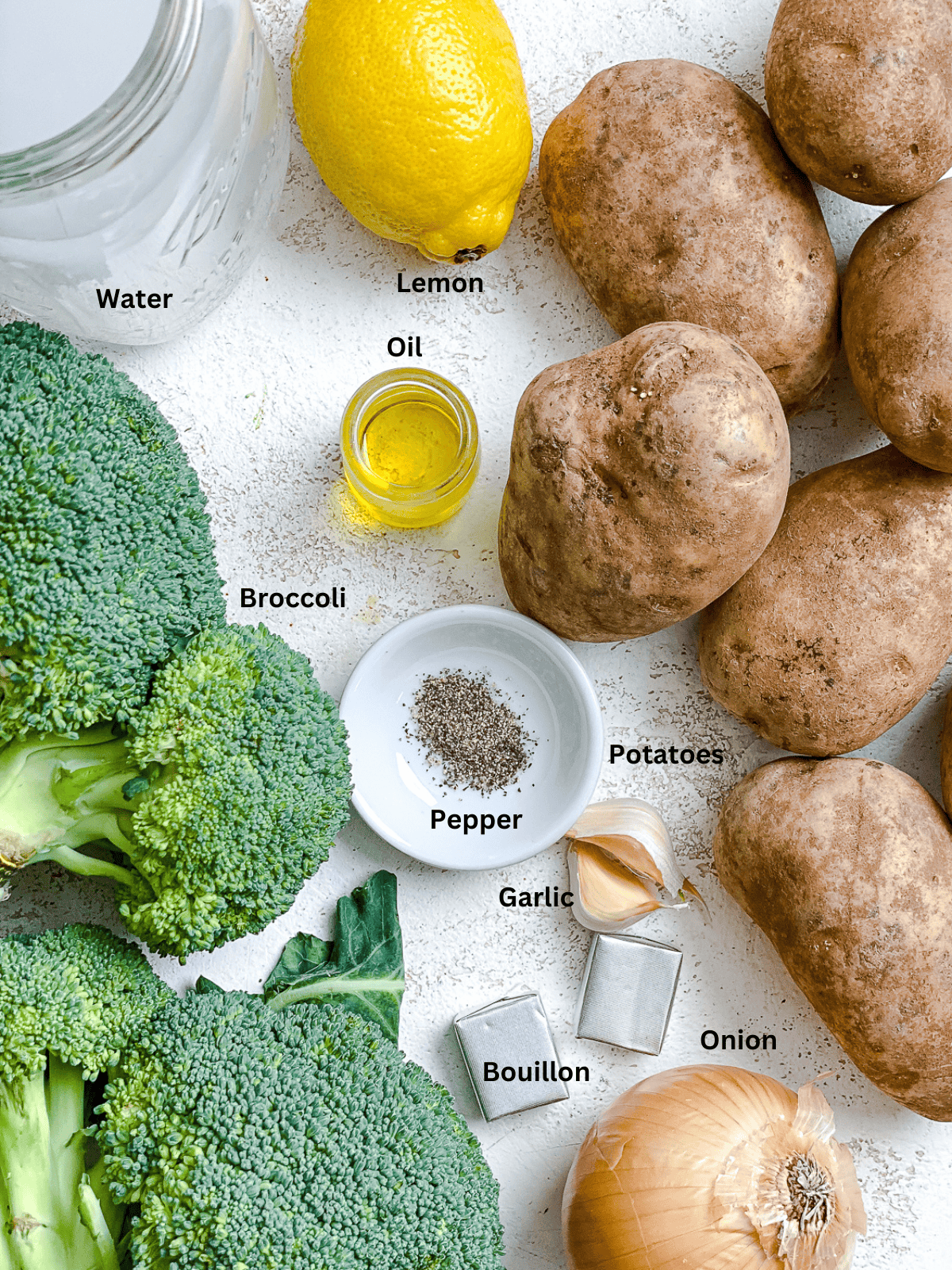 Ingredients for Vegan Broccoli Potato Soup measured out on a white surface.