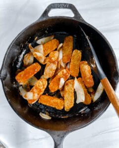 process showing cooking tempeh in a black pan