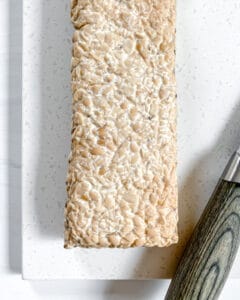 raw block of tempeh on a white surface