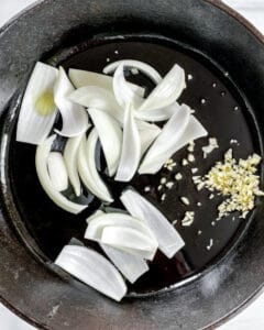 process showing onions and garlic on pan