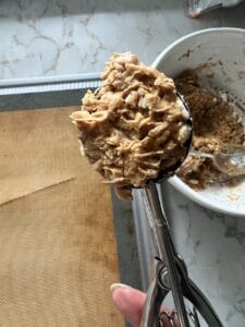 scoop of Peanut Butter Bon Bons ingredients against a silicone mat in the background