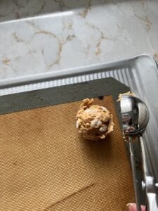 process of putting a scoop of Peanut Butter Bon Bon on a silicone mat 