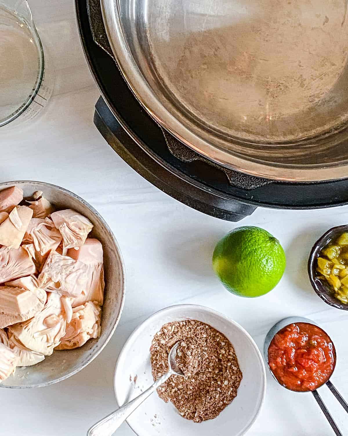 ingredients for jackfruit carnitas with slow cooker in the background