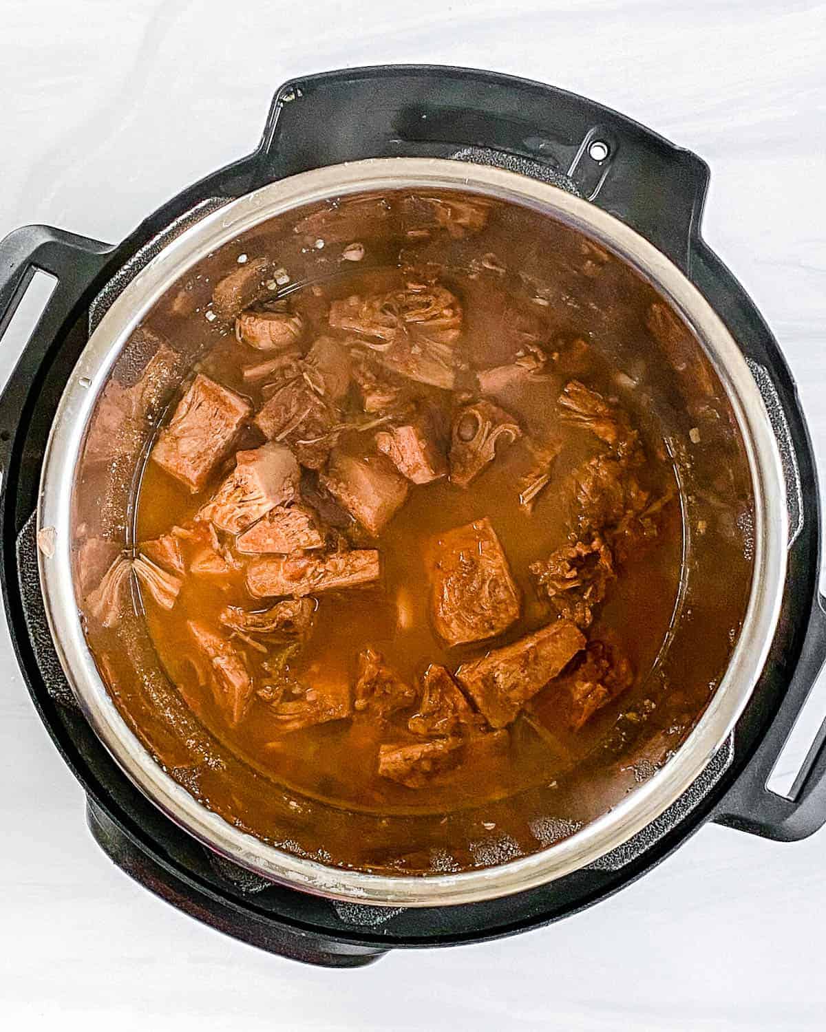 process of jackfruit carnitas in the slow cooker against white background