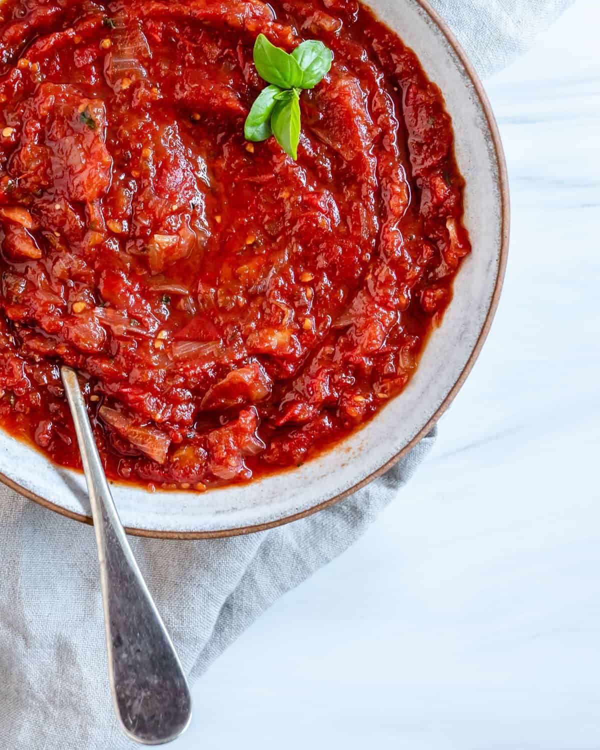 completed Sweet Tomato Chutney in a white bowl against a white background