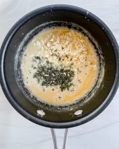 proces showing the mixing of ingredients in a black pan