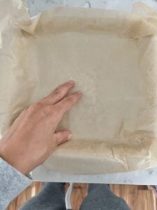 process of putting parchment paper down on tray
