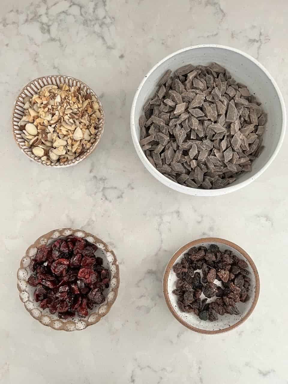 ingredients for Chocolate Fruit Bars in individual bowls against white surface