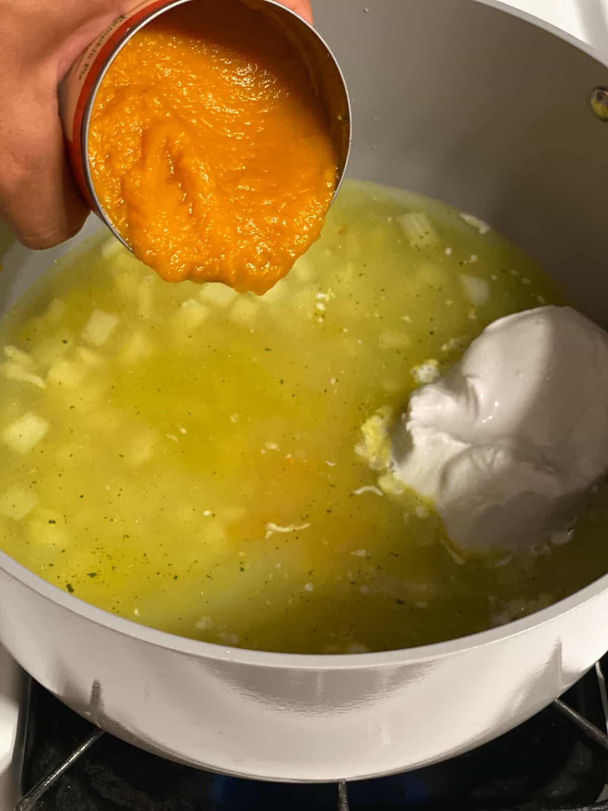 process shot of adding pumpkin to pan