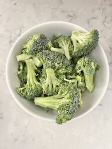 raw broccoli in a white bowl