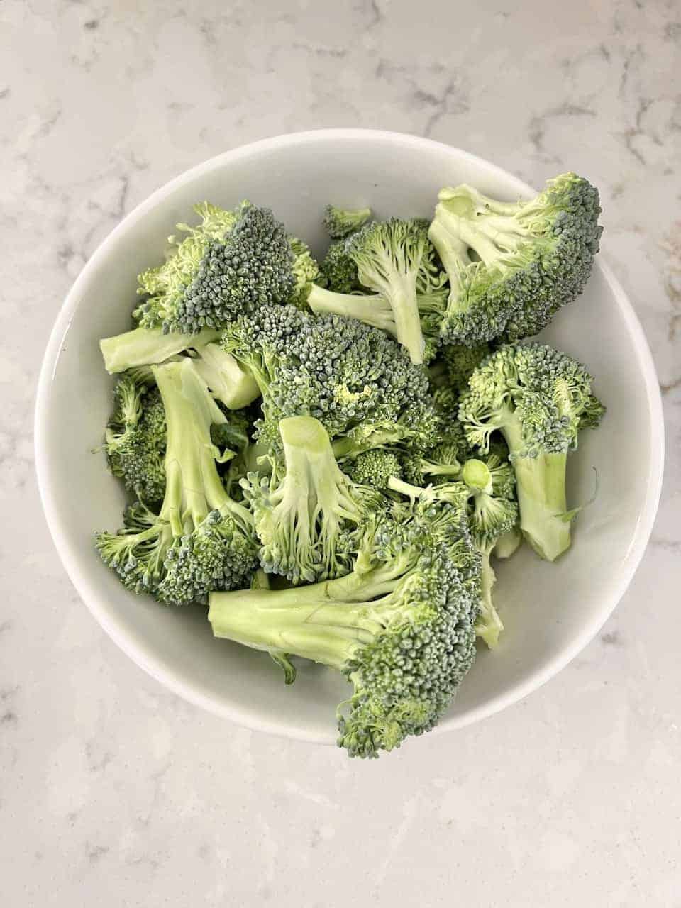 raw broccoli in a white bowl