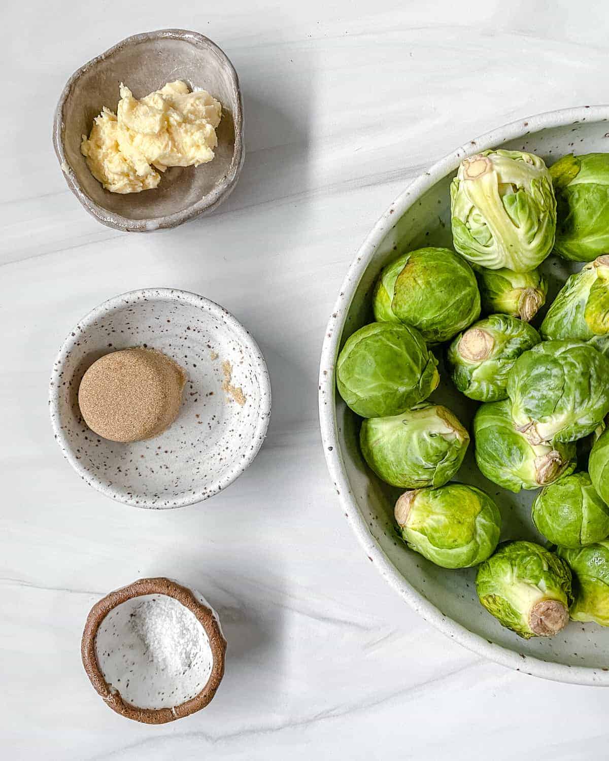 ingredients for Sweet and Salty Brussels Sprouts against a white background