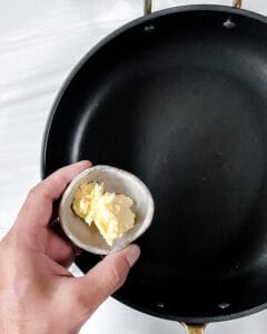 process of adding vegan butter to pan