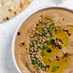 completed Easy Yellow Lentil Hummus in a white bowl against a white background