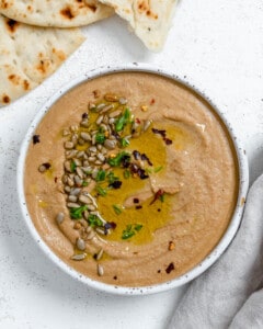 completed Easy Yellow Lentil Hummus in a white bowl against a white background