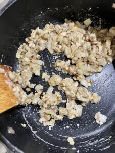 process of mixing the ingredients of mushroom gravy in a pan