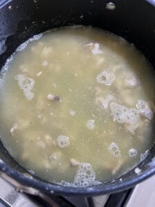process of mushroom gravy ingredients being mixed in a pan