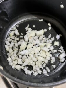 process of onions being cooked in a pan