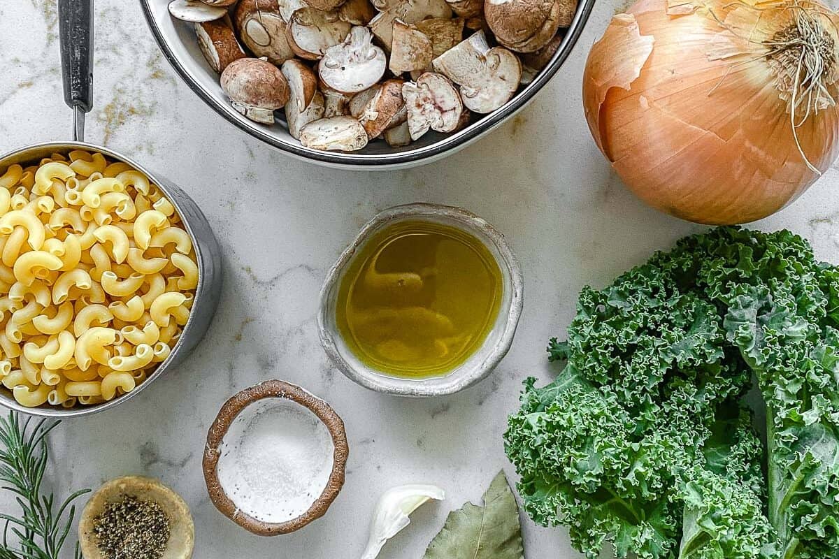 ingredients for mushroom orzo soup against a white background