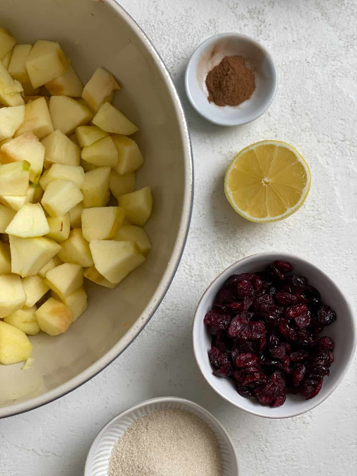 ingredients for Apple Cranberry Crisp measured out against a white surface