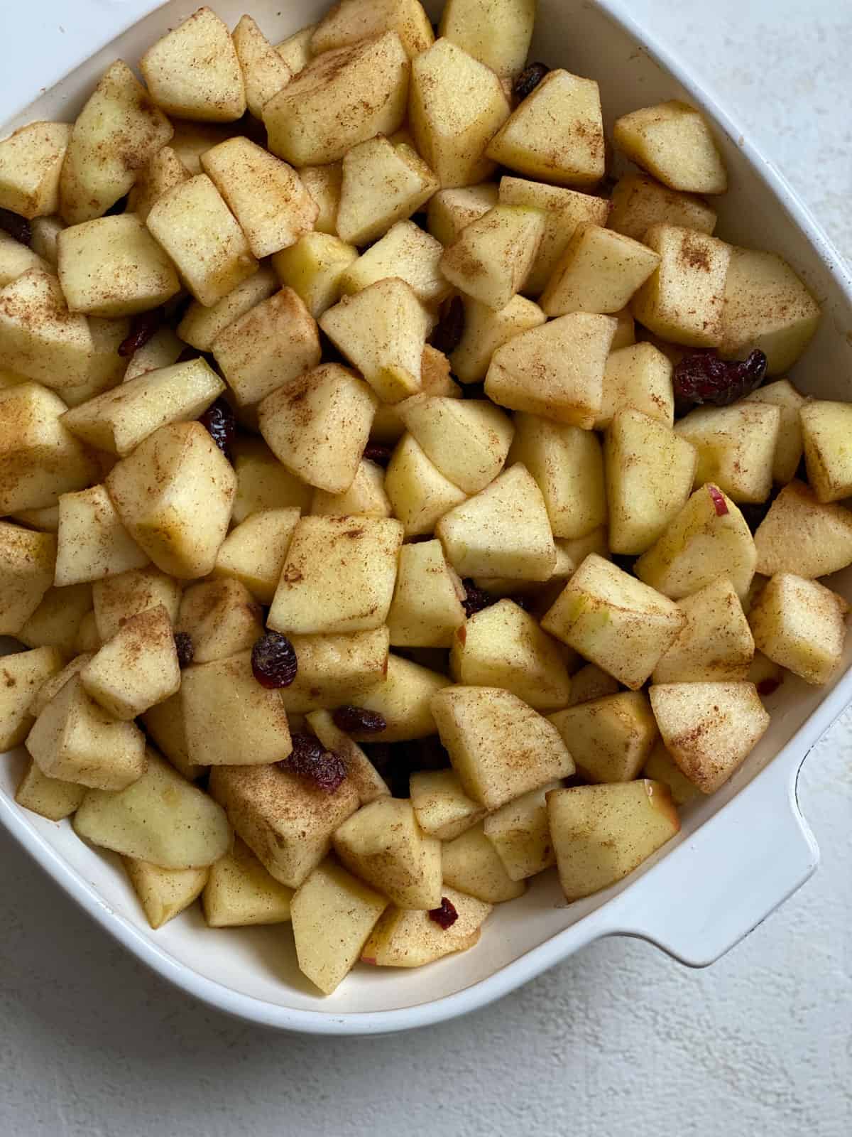 post mixing of apples and ingredients together in a bowl