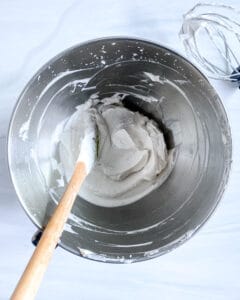 process of vegan whipped cream being mixed in a stainless steel bowl
