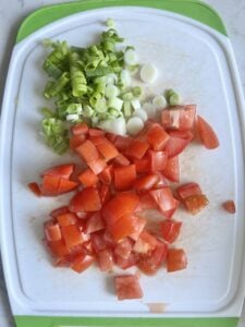chopped veggies on a white cutting board 