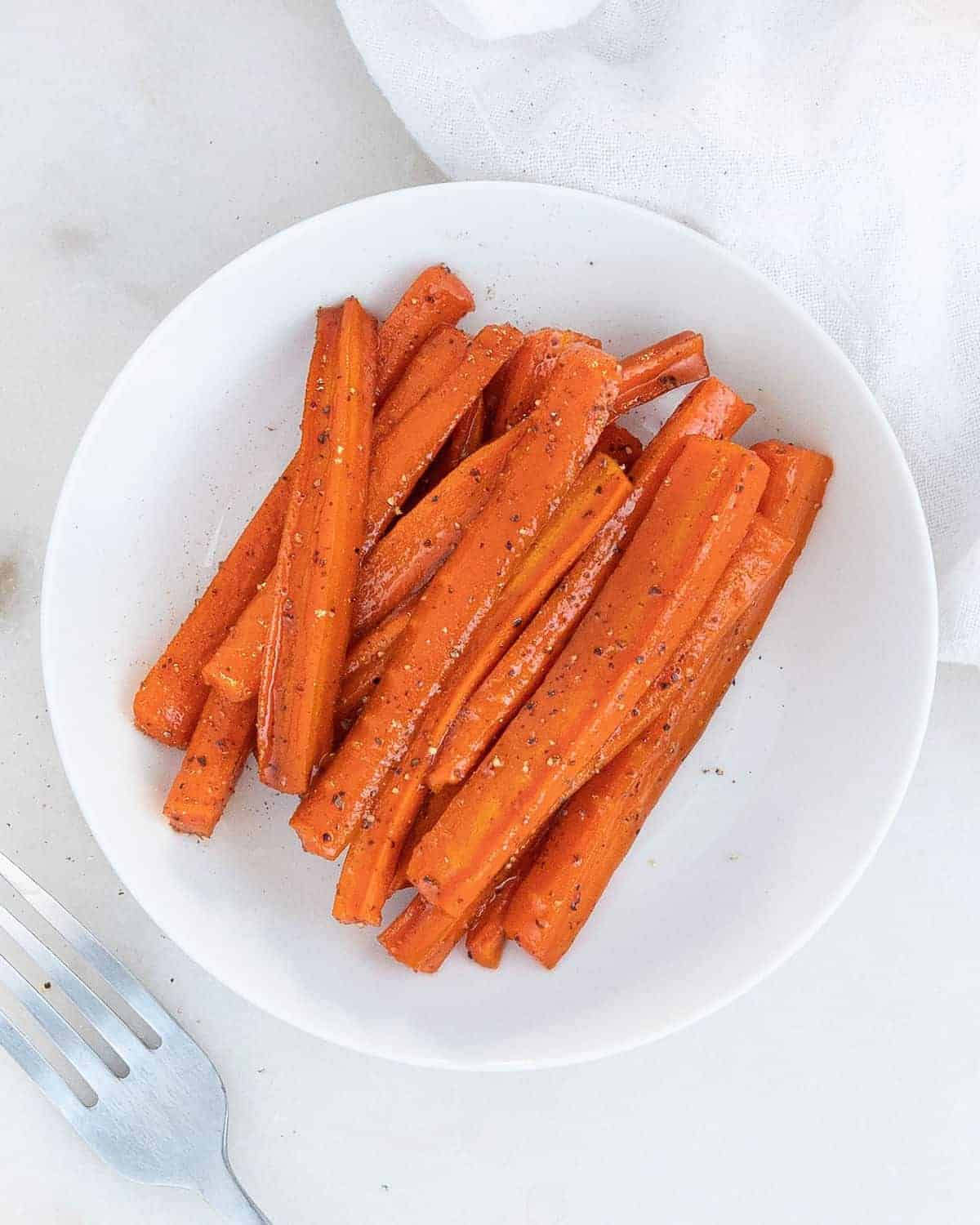 Glazed Carrots on a white plate in a white background