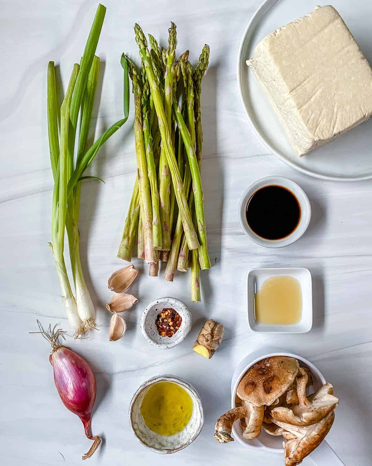 ingredients for Shiitake Asparagus Tofu Stir-fry against a white surface