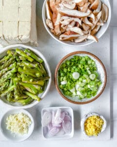 measured out ingredients for Shiitake Asparagus Tofu Stir-fry against a white surface