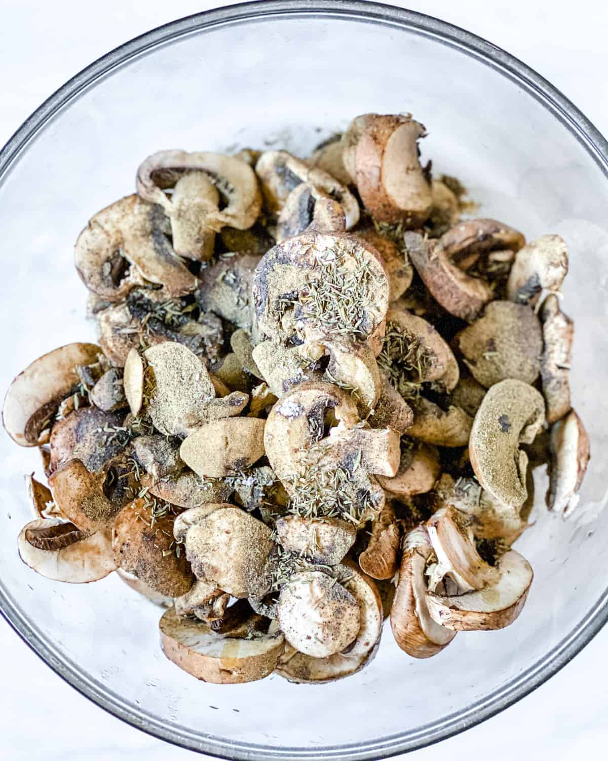 post addition of seasonings to mushrooms in a bowl