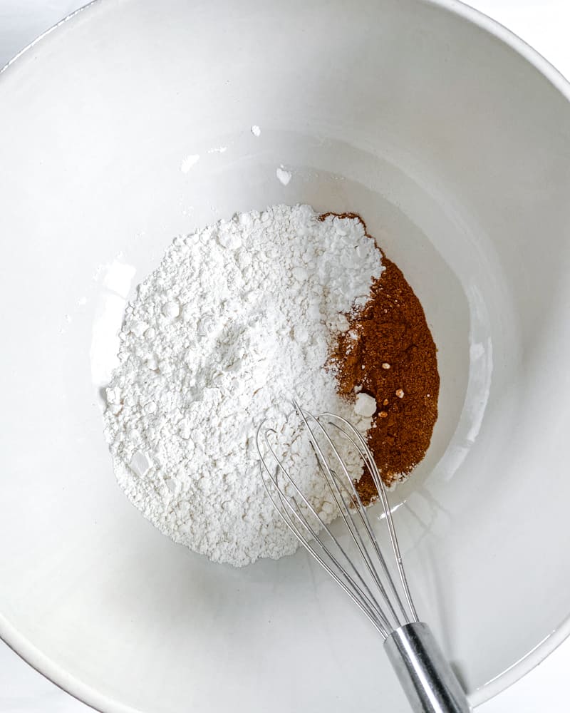 process of adding flour to bowl for vegan apple cake