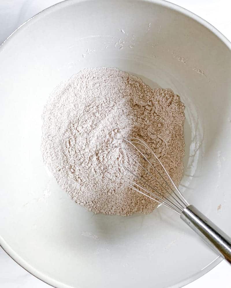 process of mixing flour to bowl for vegan apple cake