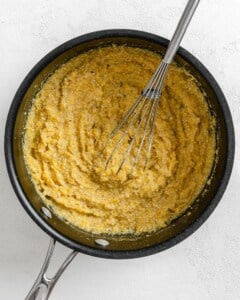 process shot of mixing polenta in a pot