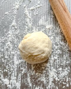 balled form of dough against gray surface