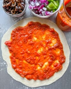 process of adding marinara to Marinara Calzone