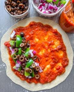 process of filling Marinara Calzone with toppings