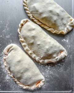 pre-backed Marinara Calzones on a gray surface